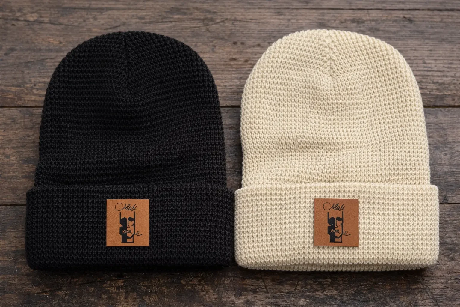 Waffle-knit Face Patch Beanies in black and cream with a leather face-logo patch