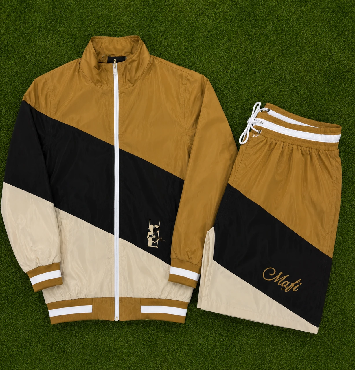 Mustard Track Set: mustard, black and cream track jacket with matching shorts on grass