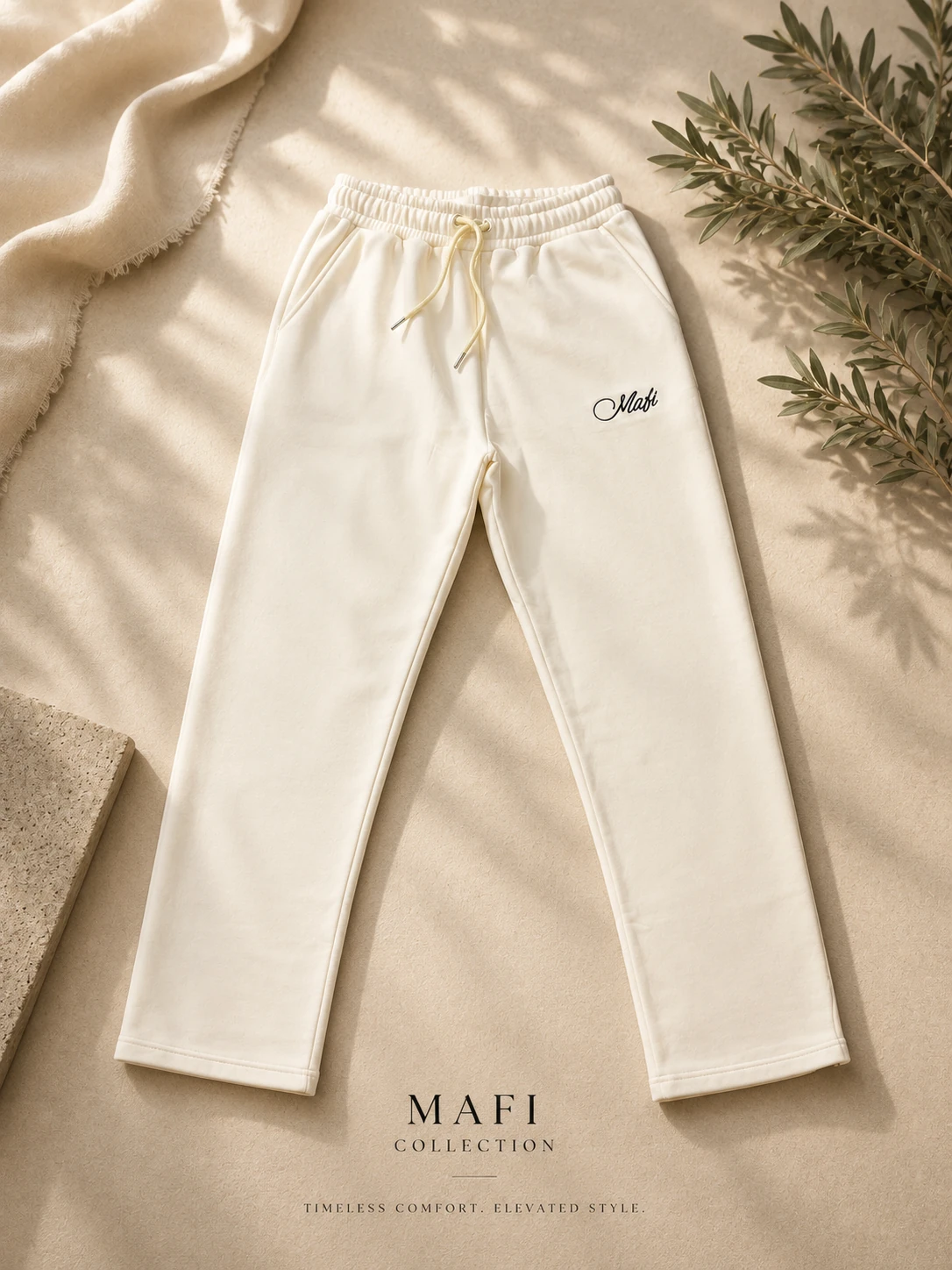 Cream MAFI sweatpants with a script logo at the thigh